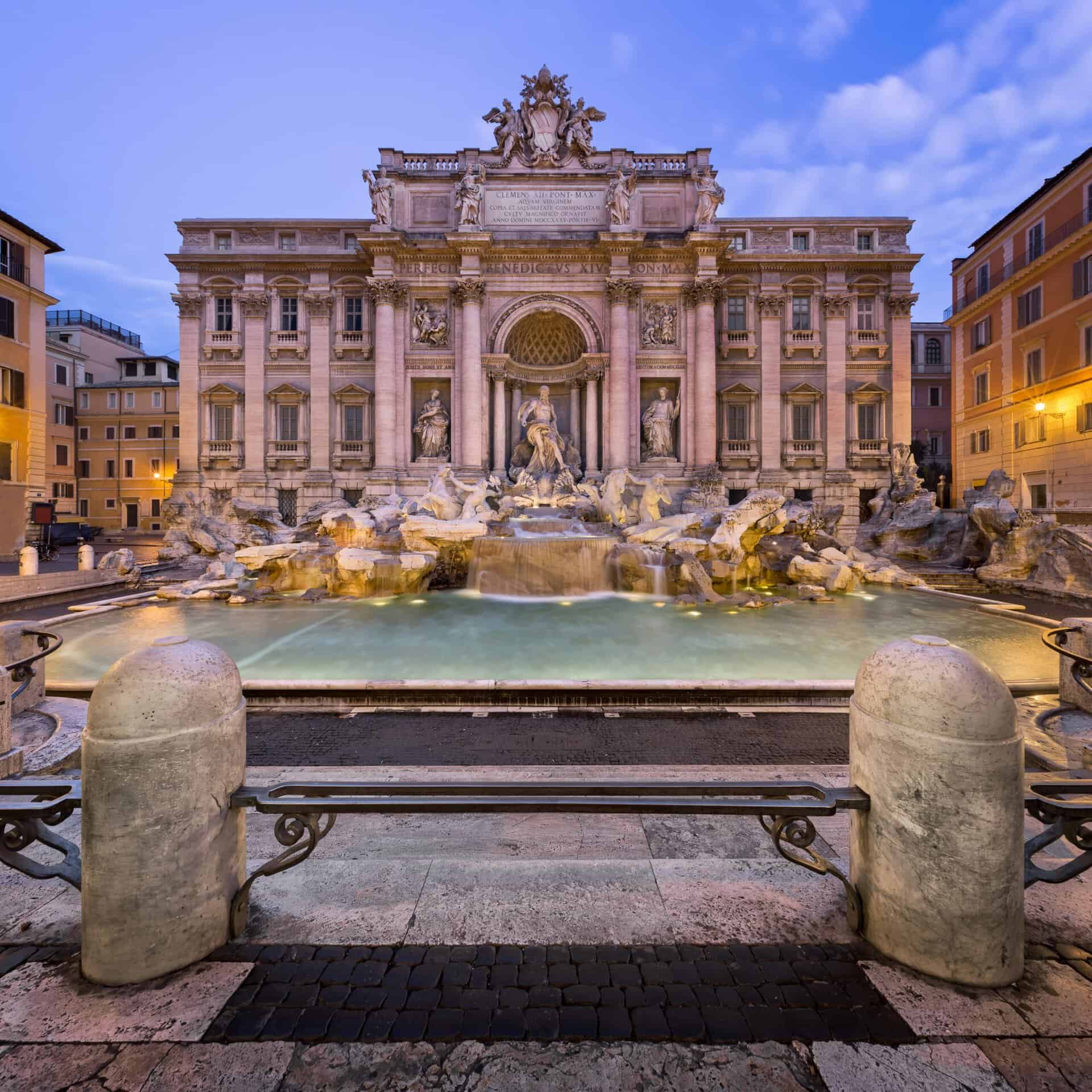 Trevi Fountain Rome panoramic front view at sunset with baroque architecture and flowing water