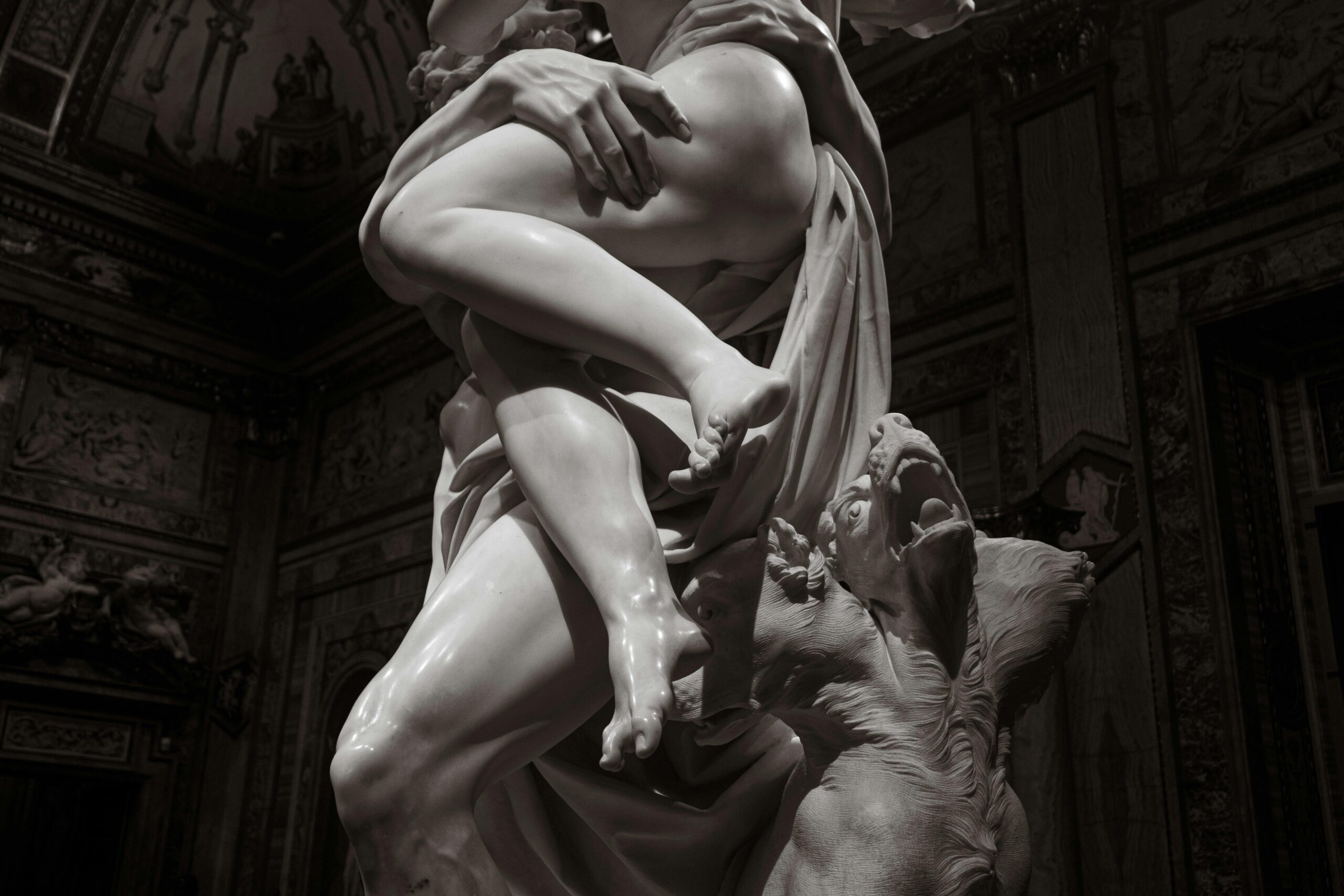 A stunning baroque marble sculpture depicting dramatic classical themes in a Roman museum.