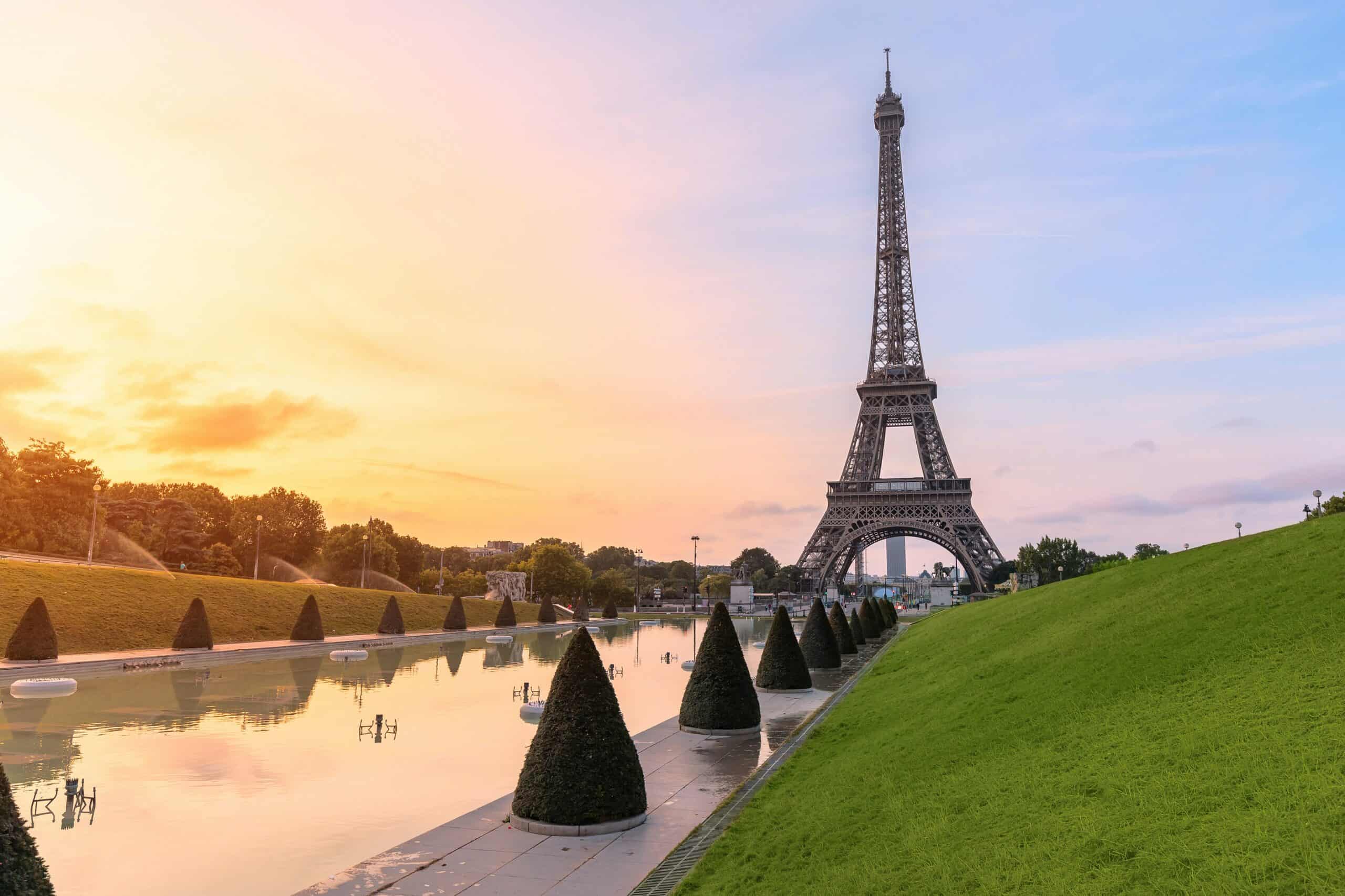 Eiffel Tower Paris sunset view from Trocadero with reflection on water and gardens