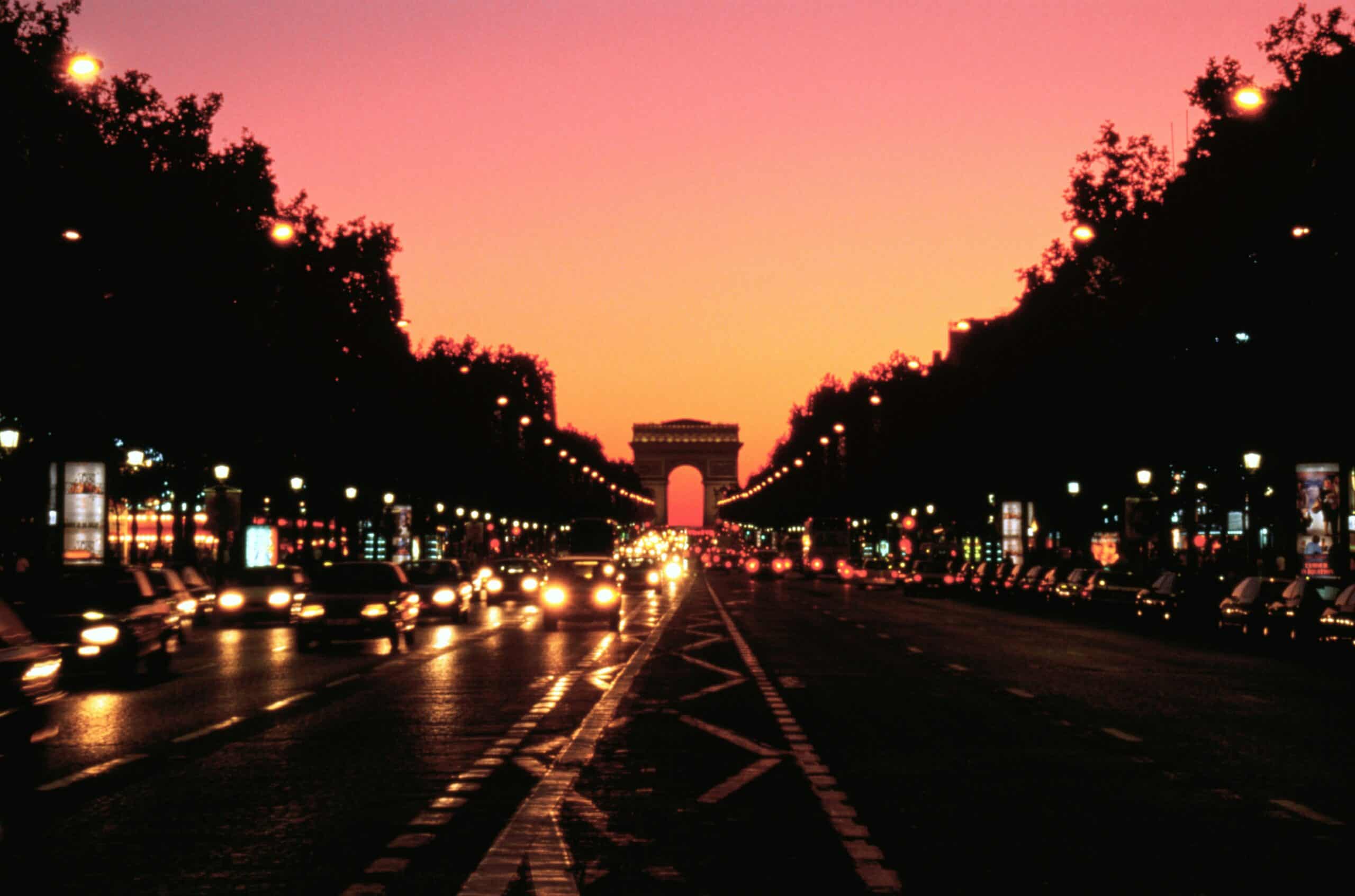 Champs-Élysées Paris night view with Arc de Triomphe and city lights