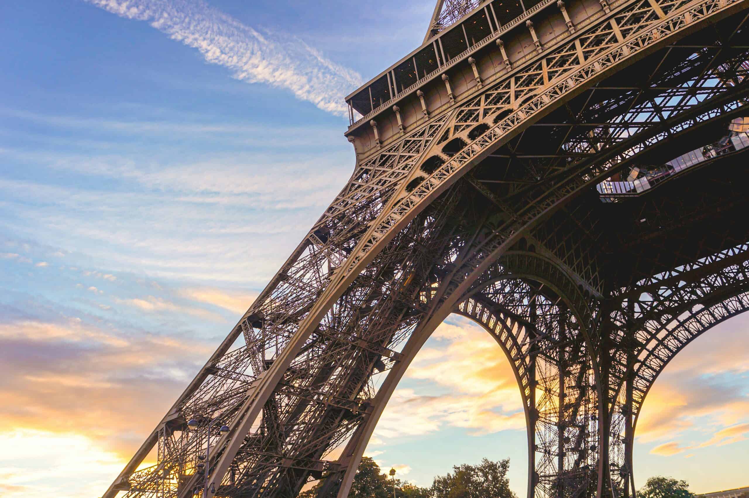 Eiffel Tower Paris iron structure from below at sunset with detailed lattice design
