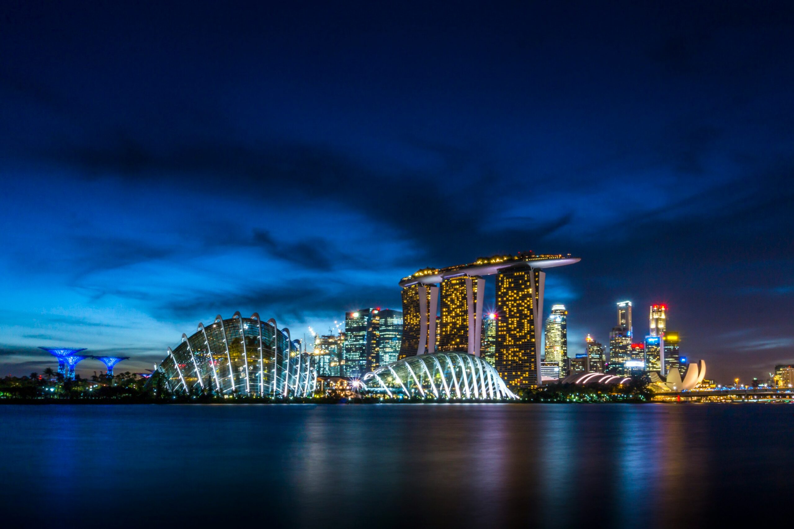 Singapore skyline at Marina Bay with illuminated skyline and waterfront at night