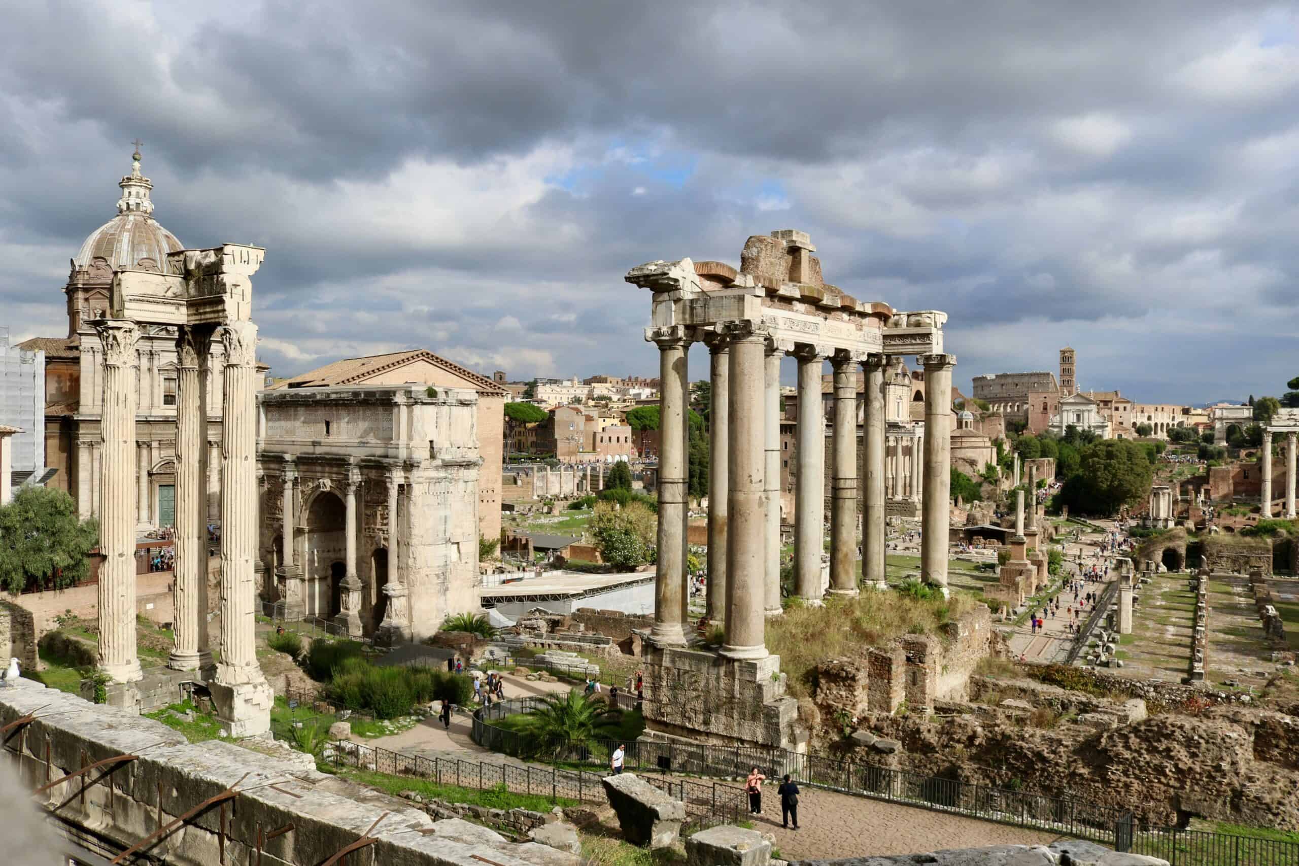 Roman Forum Rome ruins with ancient columns and historic buildings under dramatic clouds