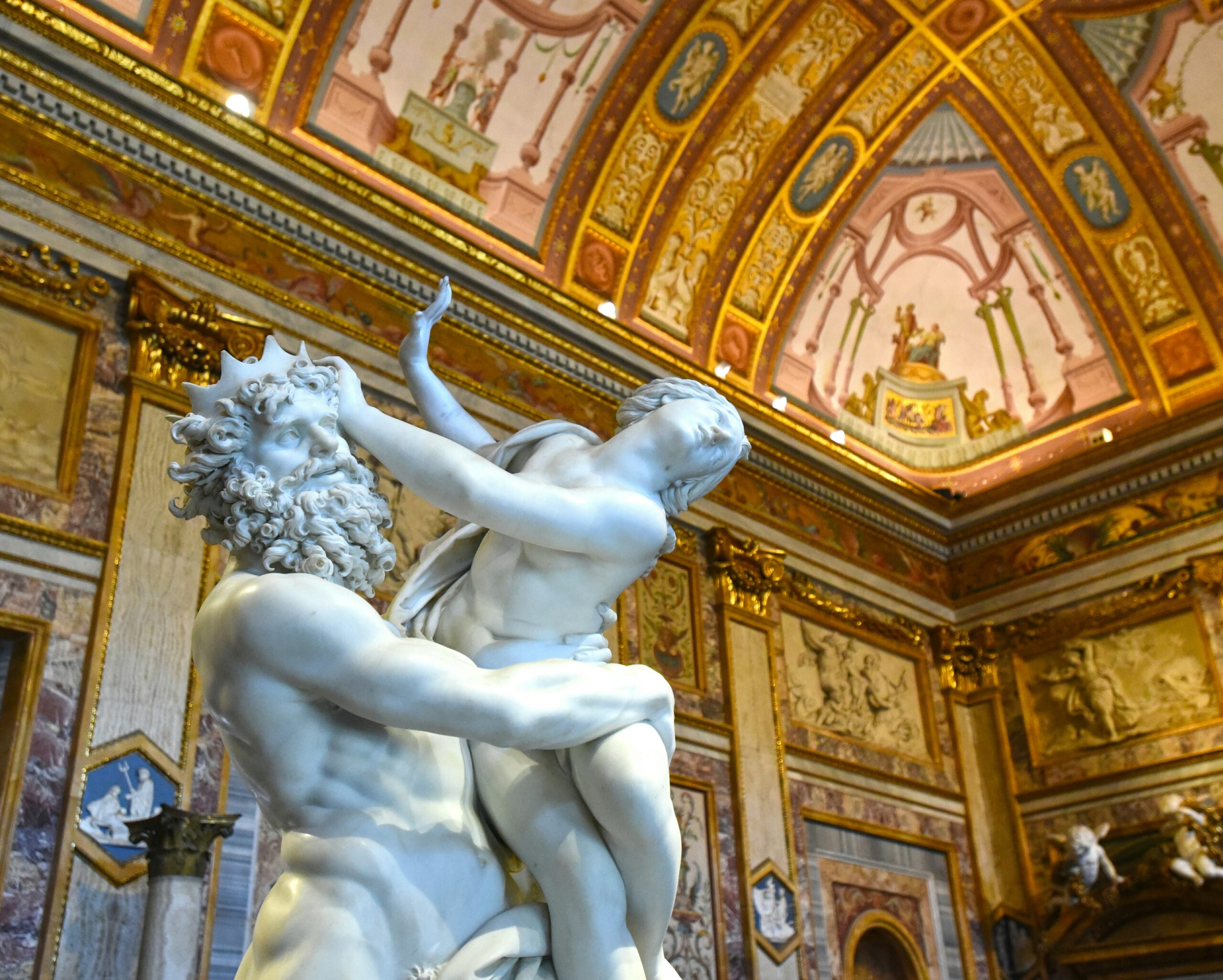 Galleria Borghese Rome interior with Bernini sculpture beneath an ornate frescoed ceiling