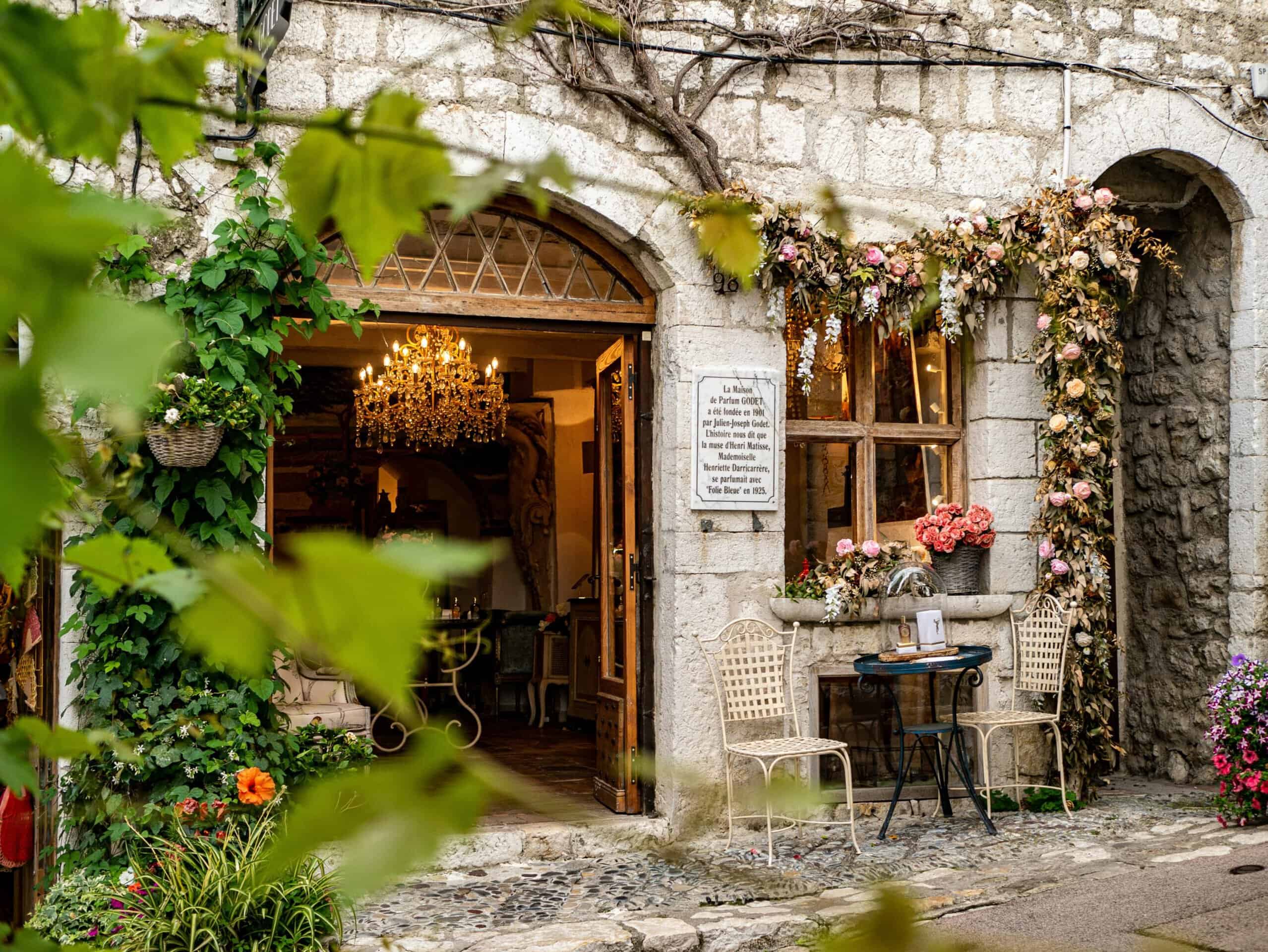 Saint-Paul-de-Vence village stone street cafe entrance with flowers and rustic architecture