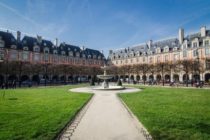 Place des Vosges Paris square with red brick arcades and central garden in the Marais