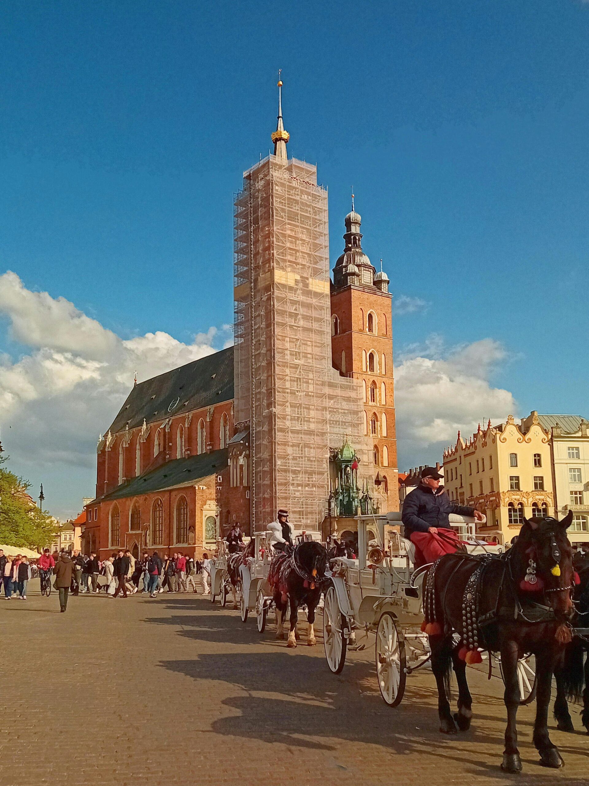 Krakow Old Town with St Mary's Basilica and horse carriage in Poland