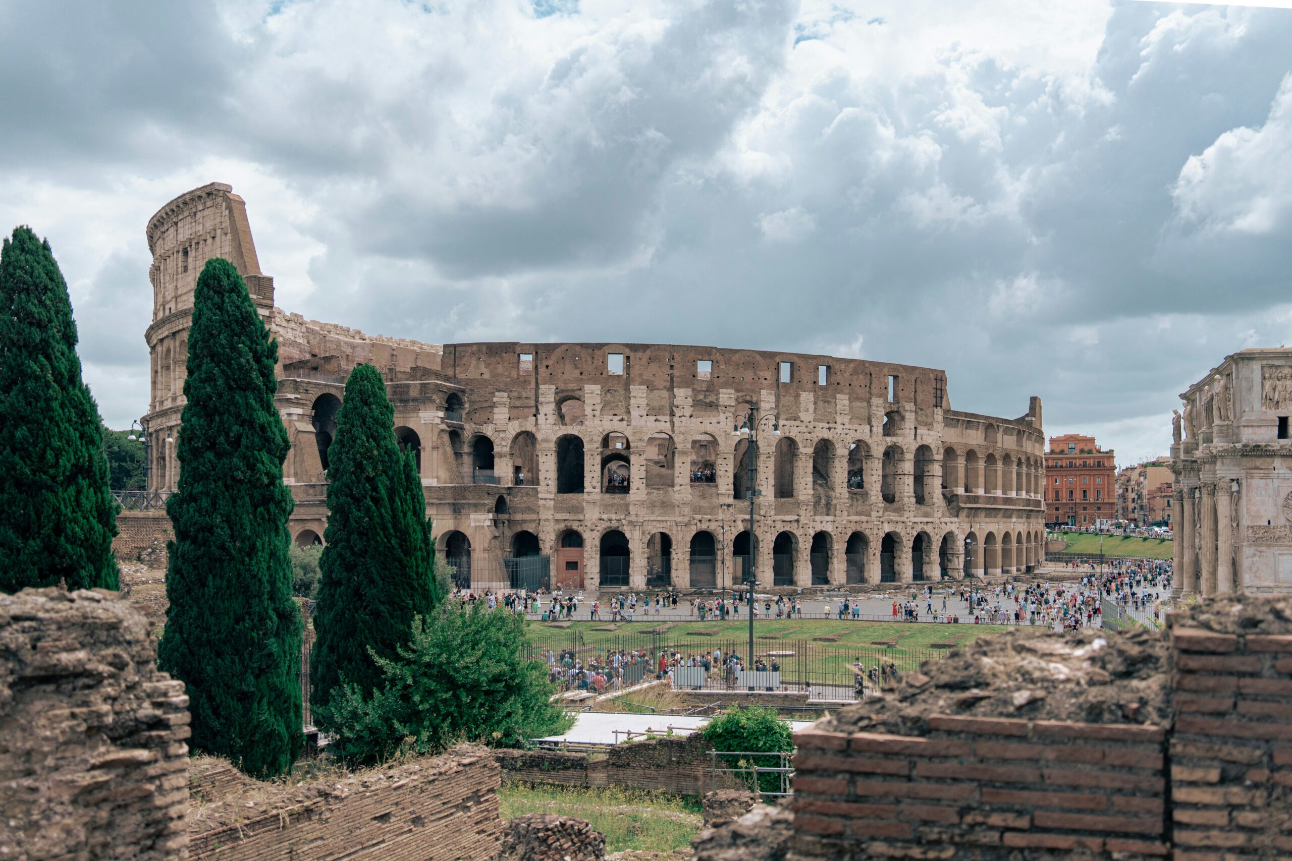 Colosseum Rome view from Palatine Hill with ancient ruins and dramatic sky
