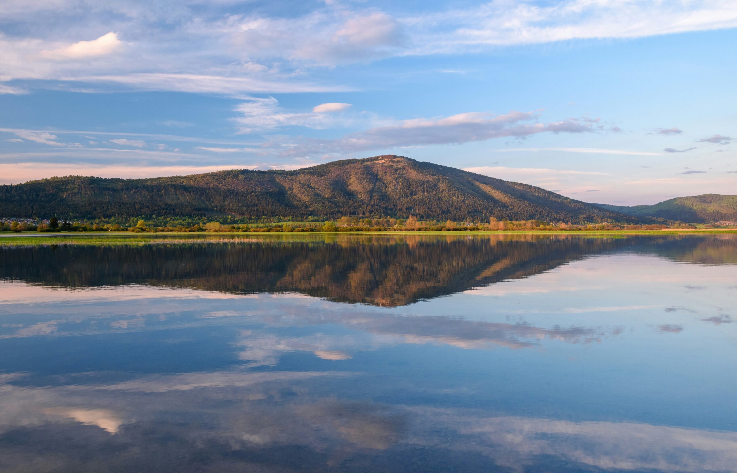 Lake Towada calm water reflection with mountains and sky in northern Japan