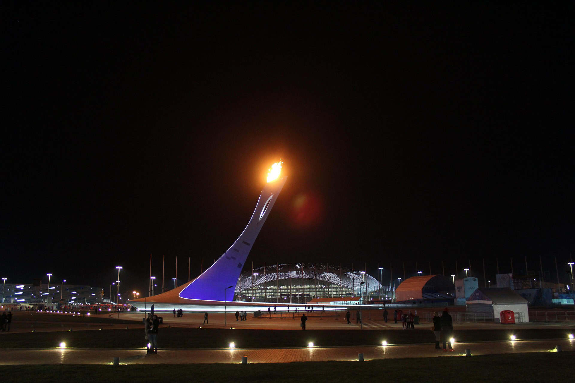 Olympic Park in Seoul at night featuring the iconic Olympic flame structure and illuminated stadium area