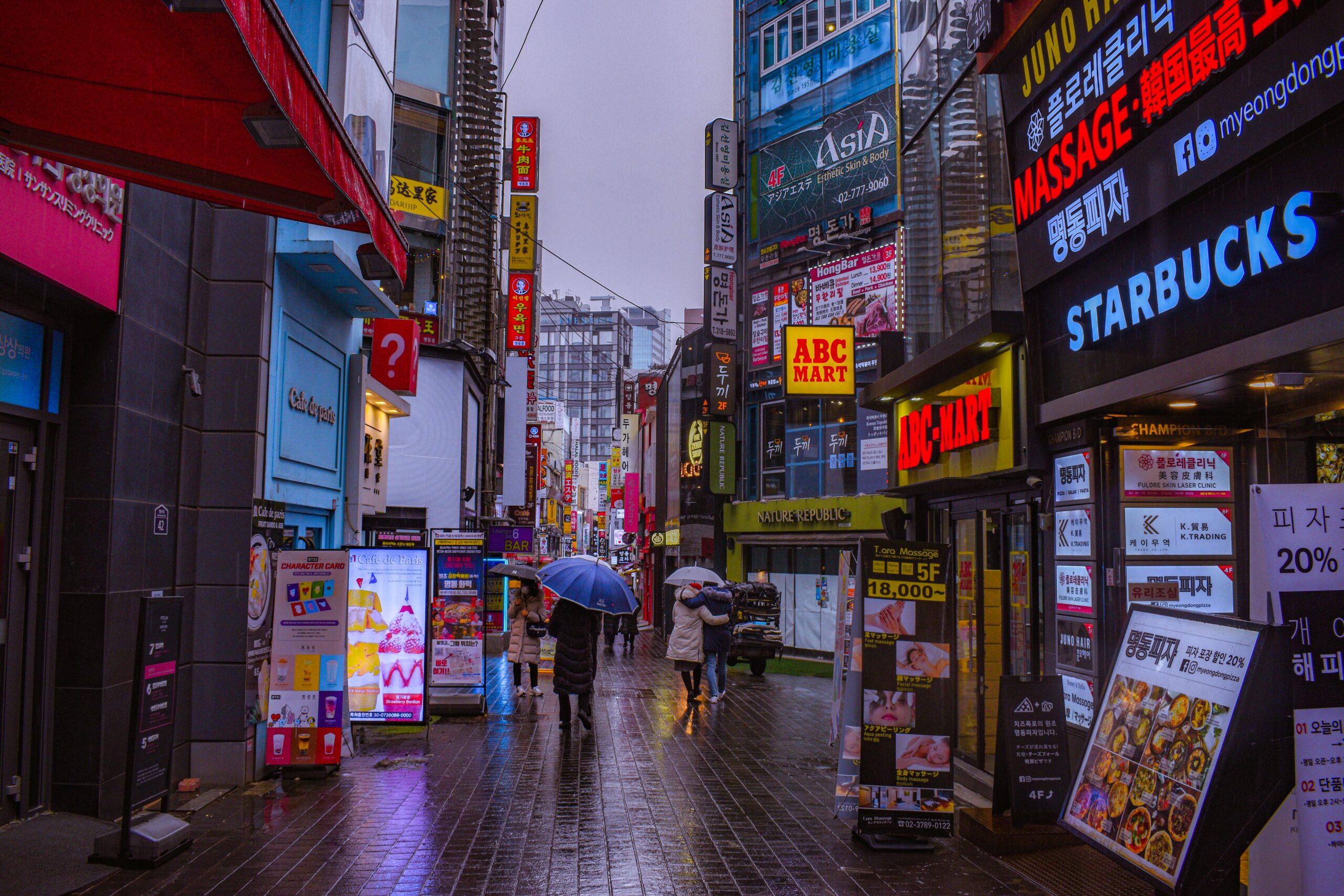 Myeongdong Shopping Street at night with neon signs and busy shopping streets in Seoul