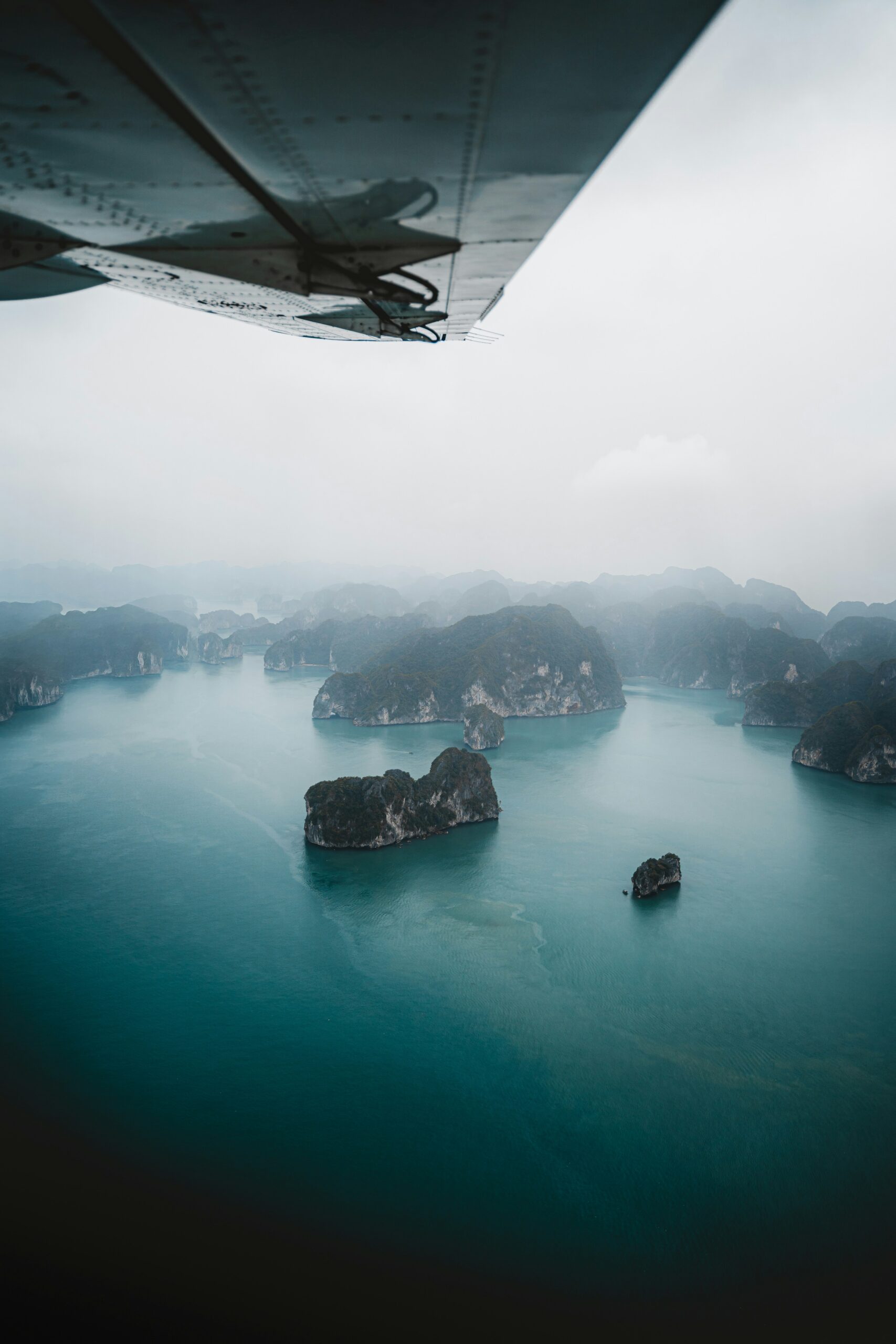 Vietnam arrival guide for first-time travelers aerial view of misty bay and limestone islands