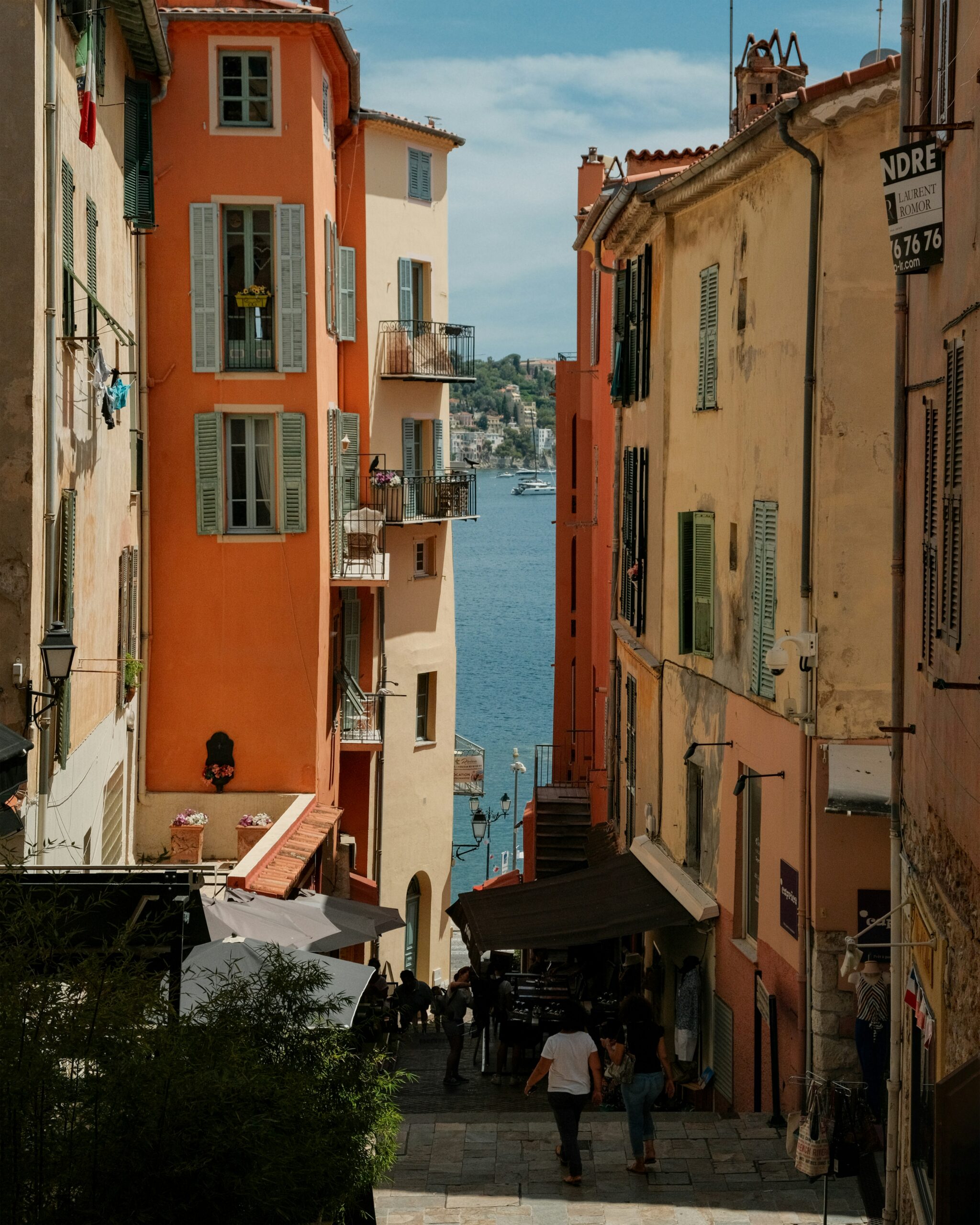 Villefranche-sur-Mer Old Town narrow alley with colorful buildings and Mediterranean sea view French Riviera