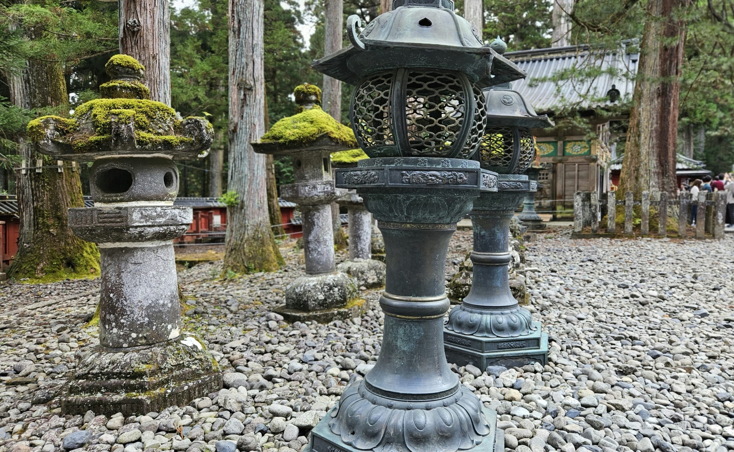 stone lanterns along shrine path in Nikko National Park Japan