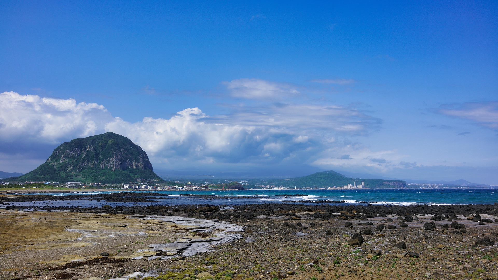 Sanbangsan Area in Seogwipo wide coastal landscape with volcanic mountain and rocky shore Jeju Island