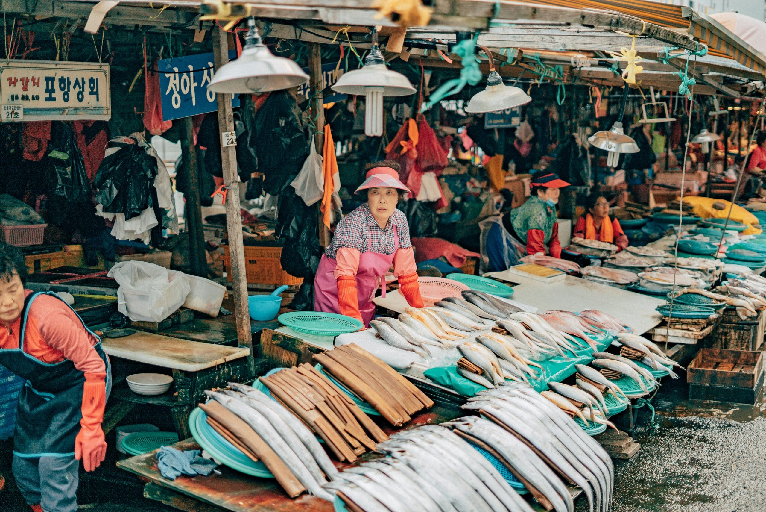 Jagalchi Ajumma selling fresh fish at the bustling outdoor street stalls of Jagalchi Market Busan