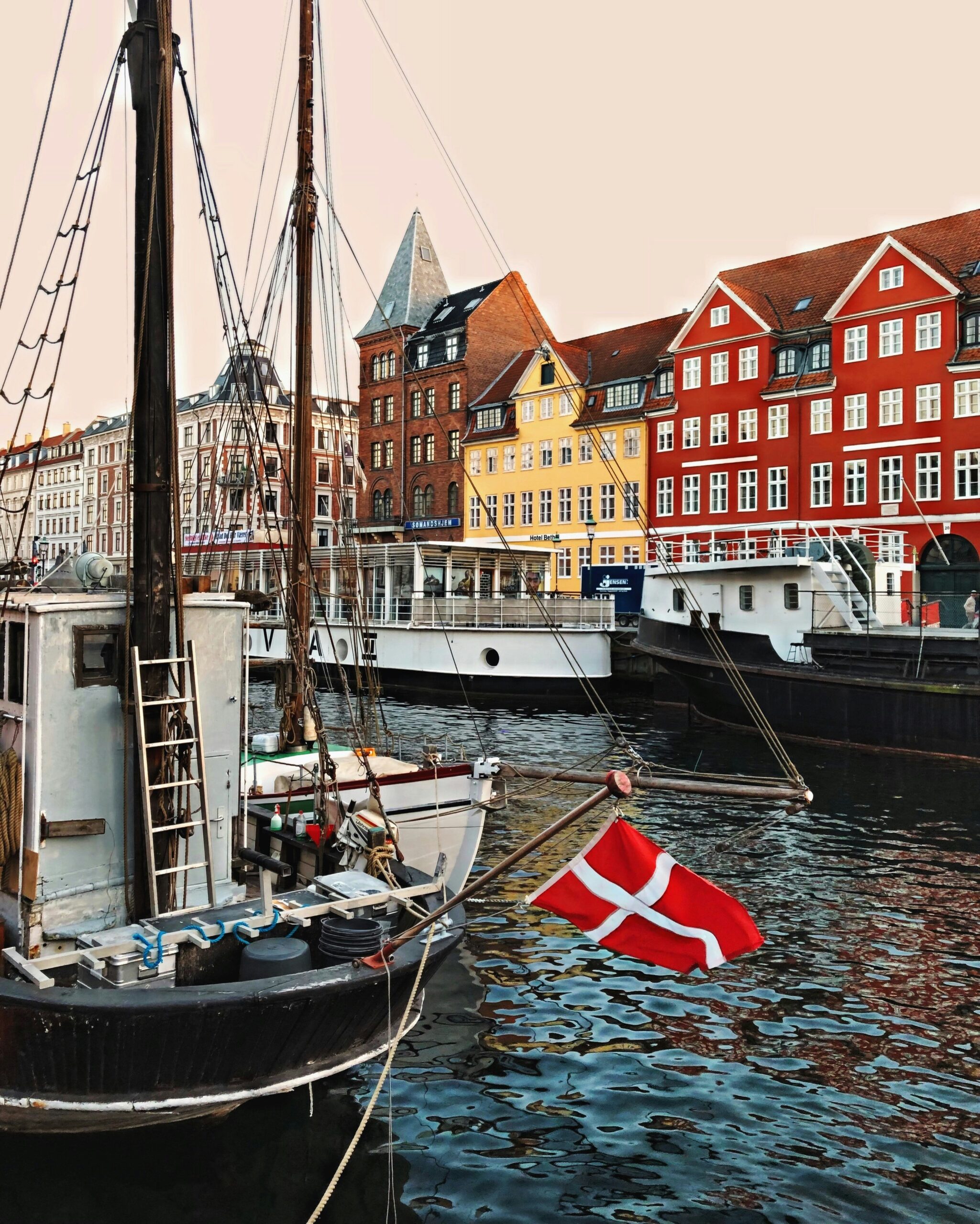 Colorful Nyhavn waterfront in Copenhagen Denmark with boats and historic canal houses