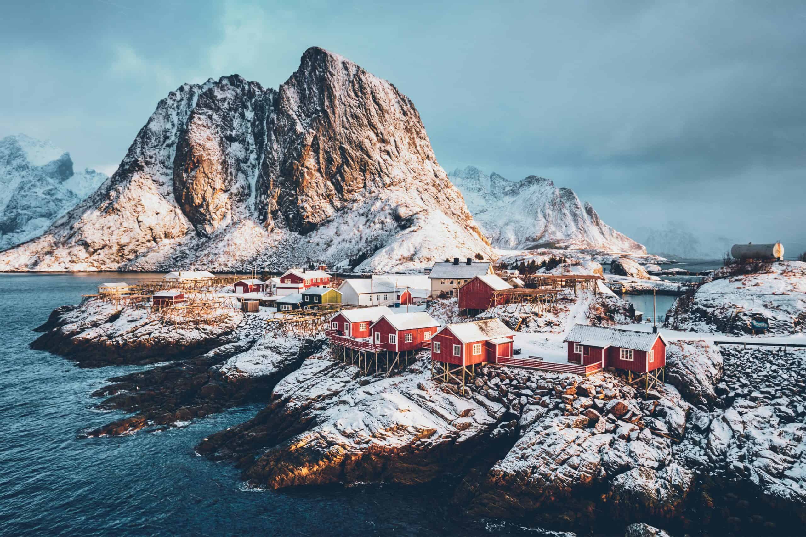 Norway Lofoten islands winter landscape red fishing cabins snowy mountains fjord scenery