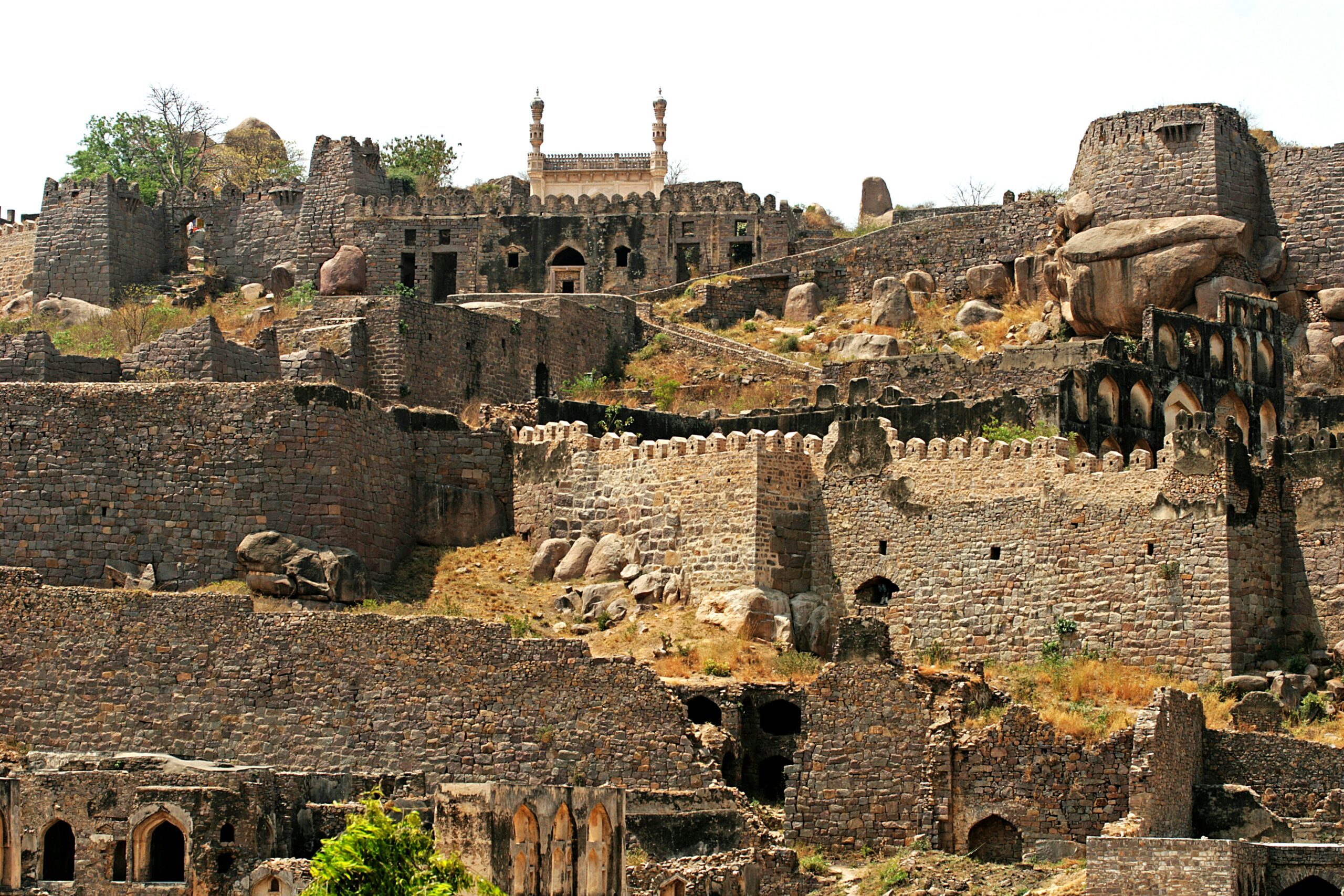 Daytime panoramic view of Pompeii Archaeological Park ruins in Campania, Italy, with Mount Vesuvius in the background.