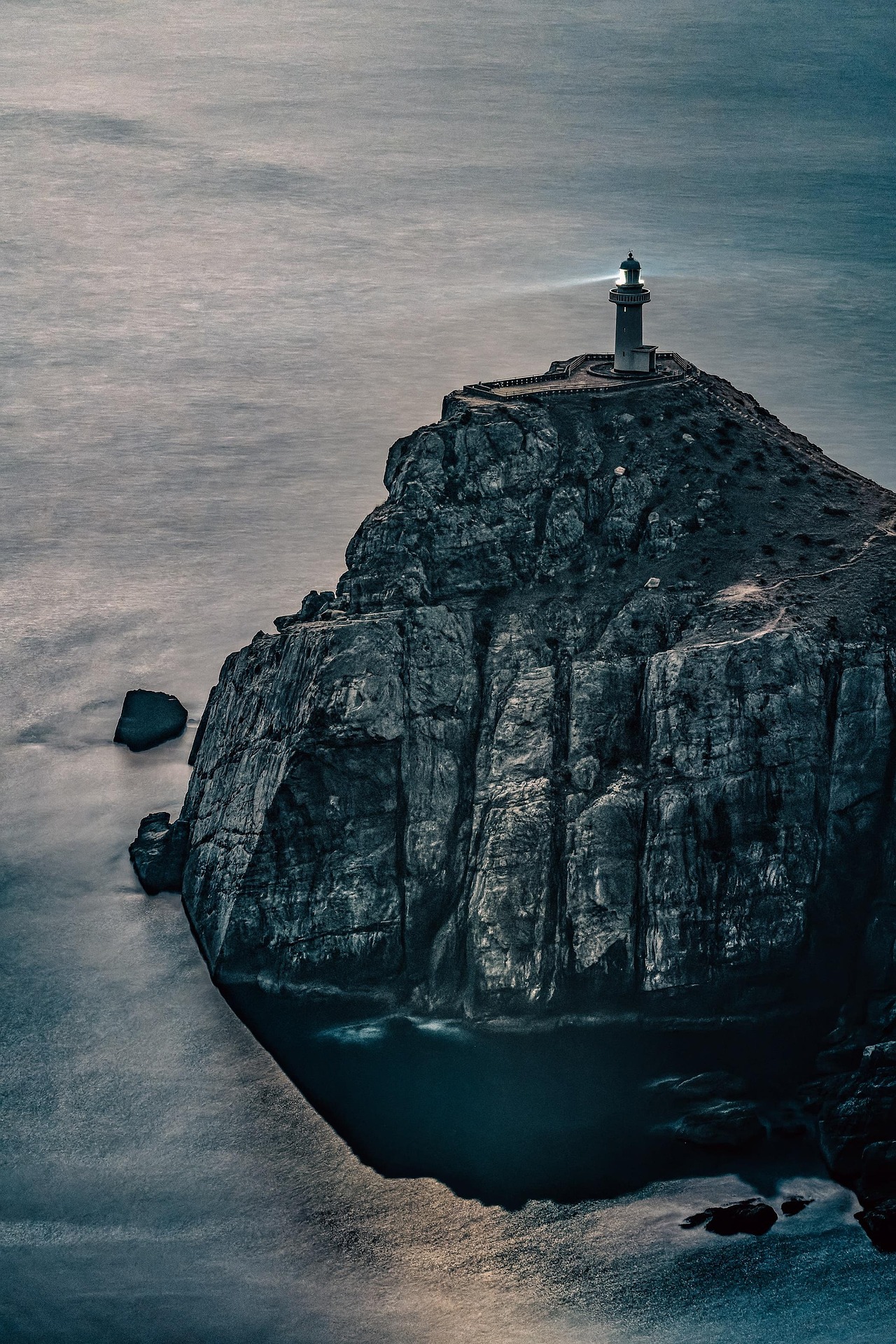 Cape Manzamo Okinawa dramatic coastal cliffs and ocean view with lighthouse silhouette