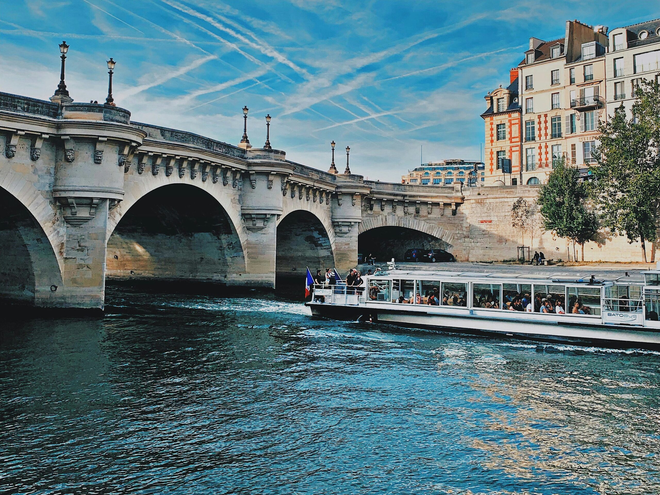 Pont Neuf bridge Paris over the Seine River with river cruise boat