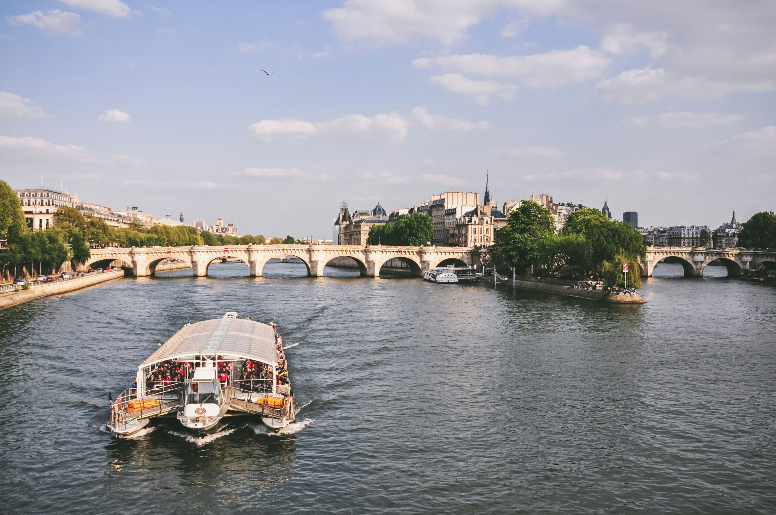 Pont Neuf and Seine River with sightseeing boat in Paris