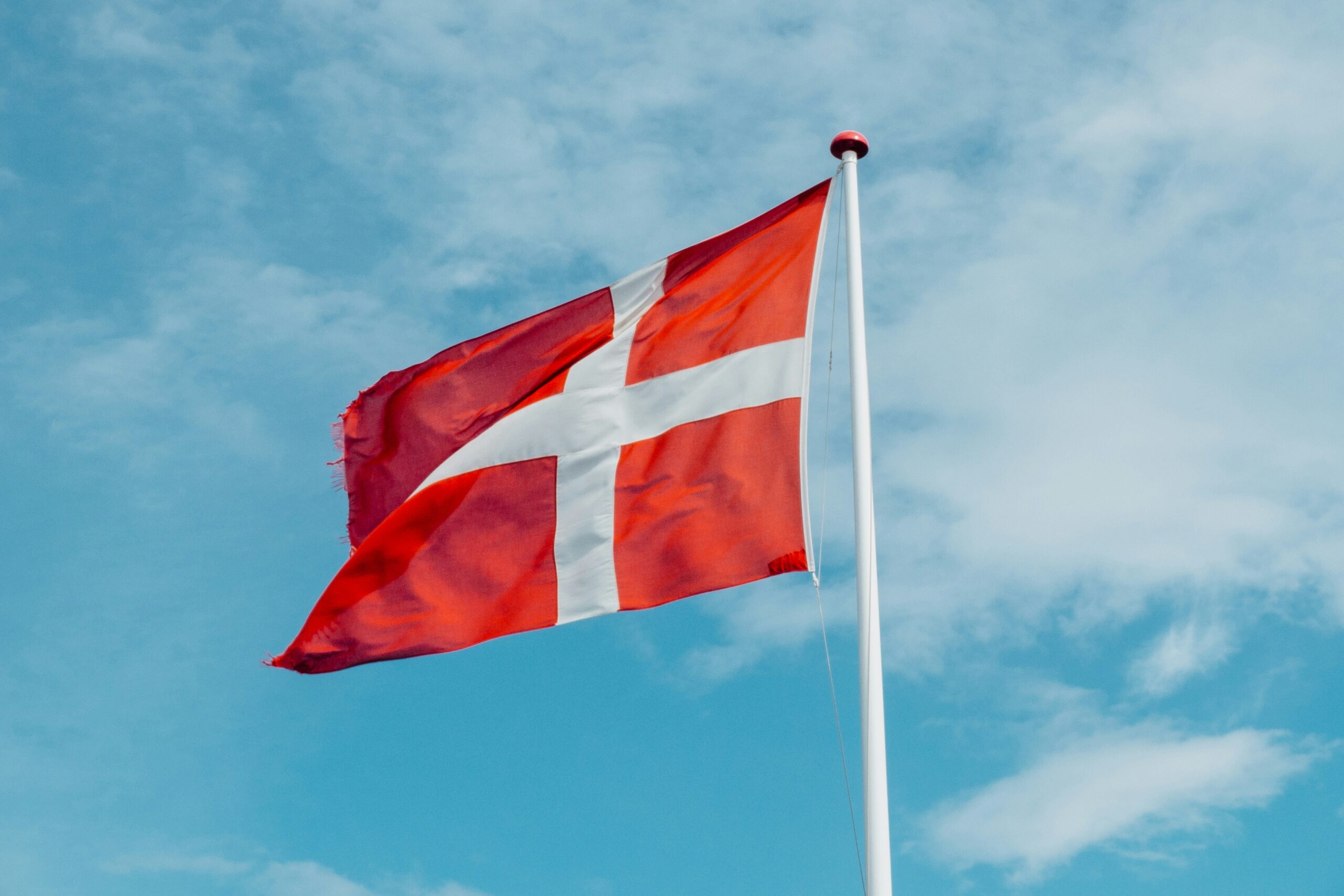 Denmark national flag waving against blue sky in Copenhagen