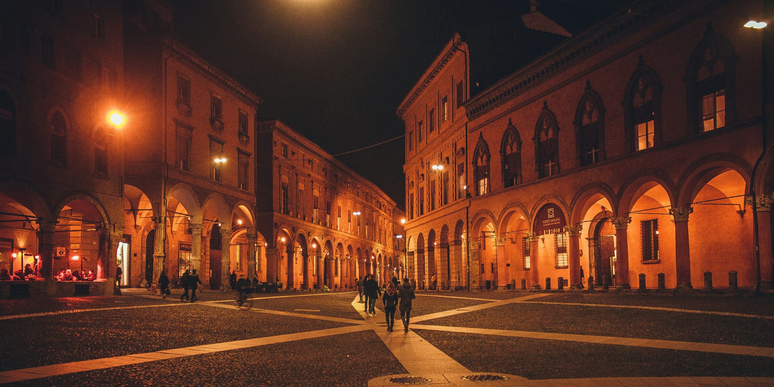 Bologna Piazza Maggiore at night with illuminated historic buildings in Italy