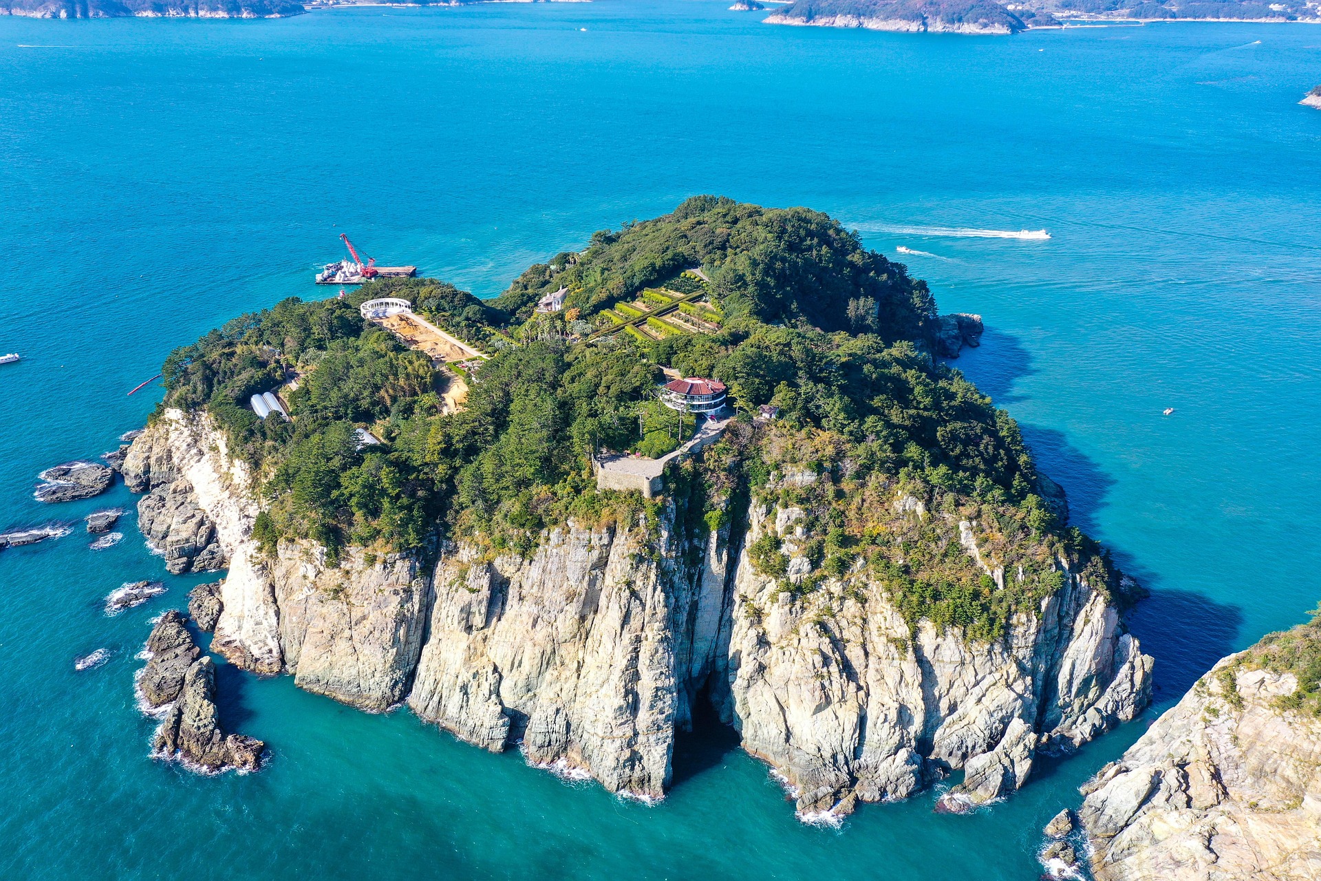 Aerial view of Oedo Botania island near Geoje, South Korea, with rocky cliffs and turquoise sea.