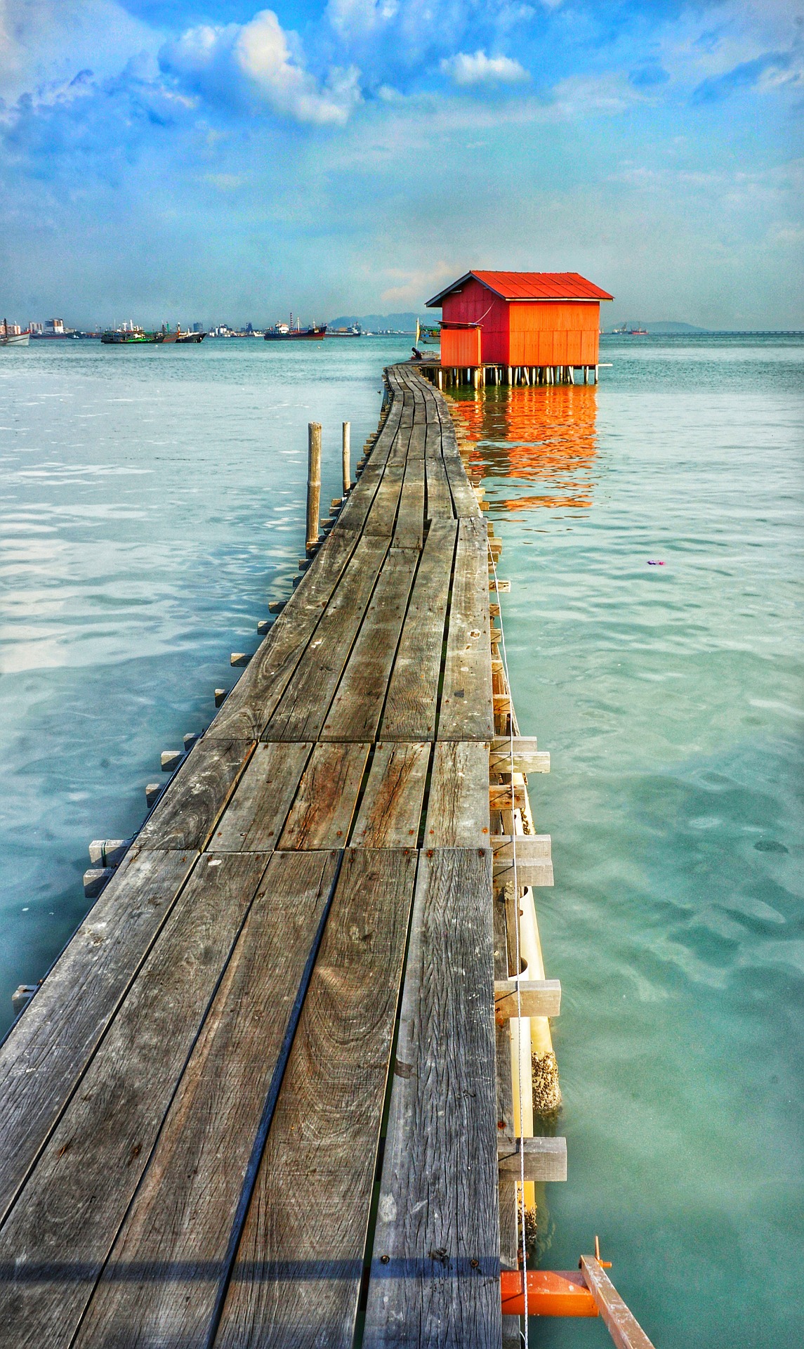 Malaysia tropical beach wooden walkway over clear sea