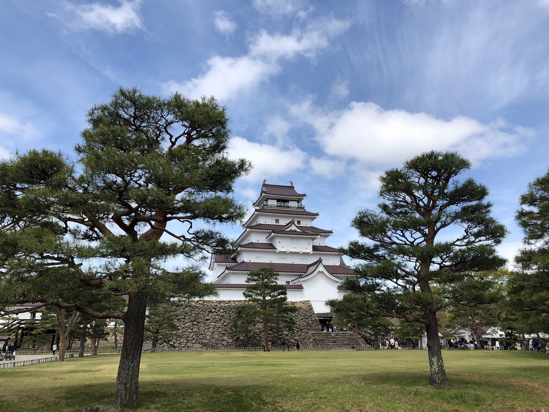 Tsuruga Castle in Aizuwakamatsu surrounded by pine trees under blue sky Fukushima Japan