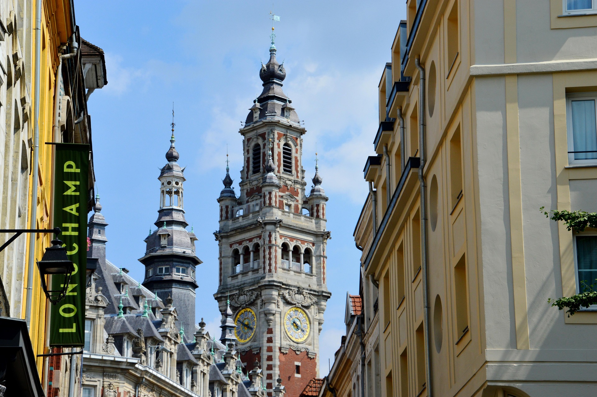 Old Lille street view with historic bell towers rising above colorful buildings in Lille, France