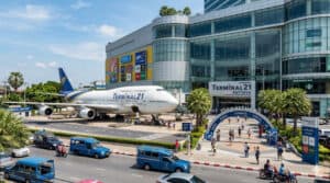Terminal 21 Pattaya shopping mall exterior with airplane sculpture and busy street in Pattaya Thailand