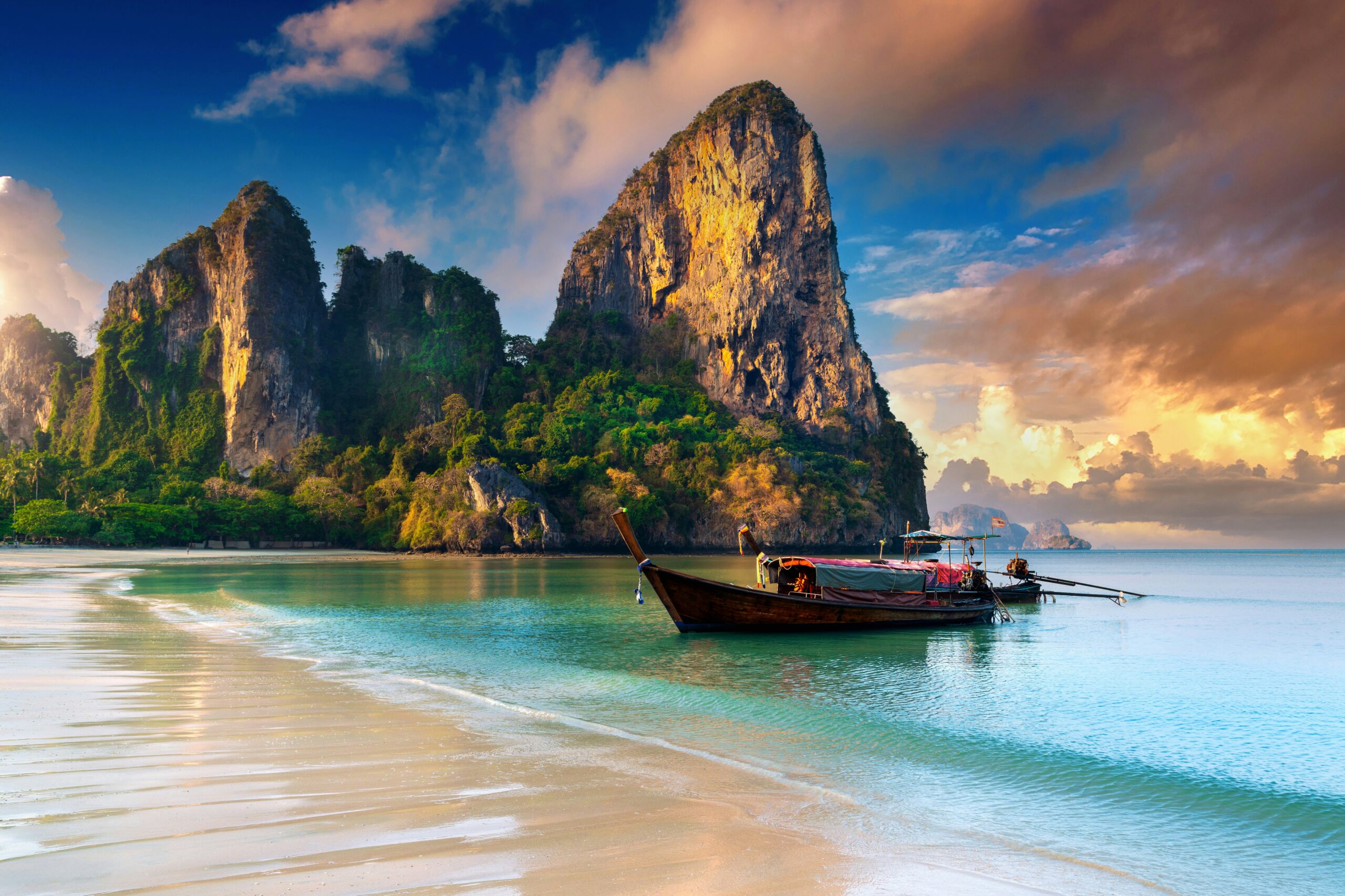 Thailand hidden destinations longtail boat limestone cliffs tropical beach lagoon